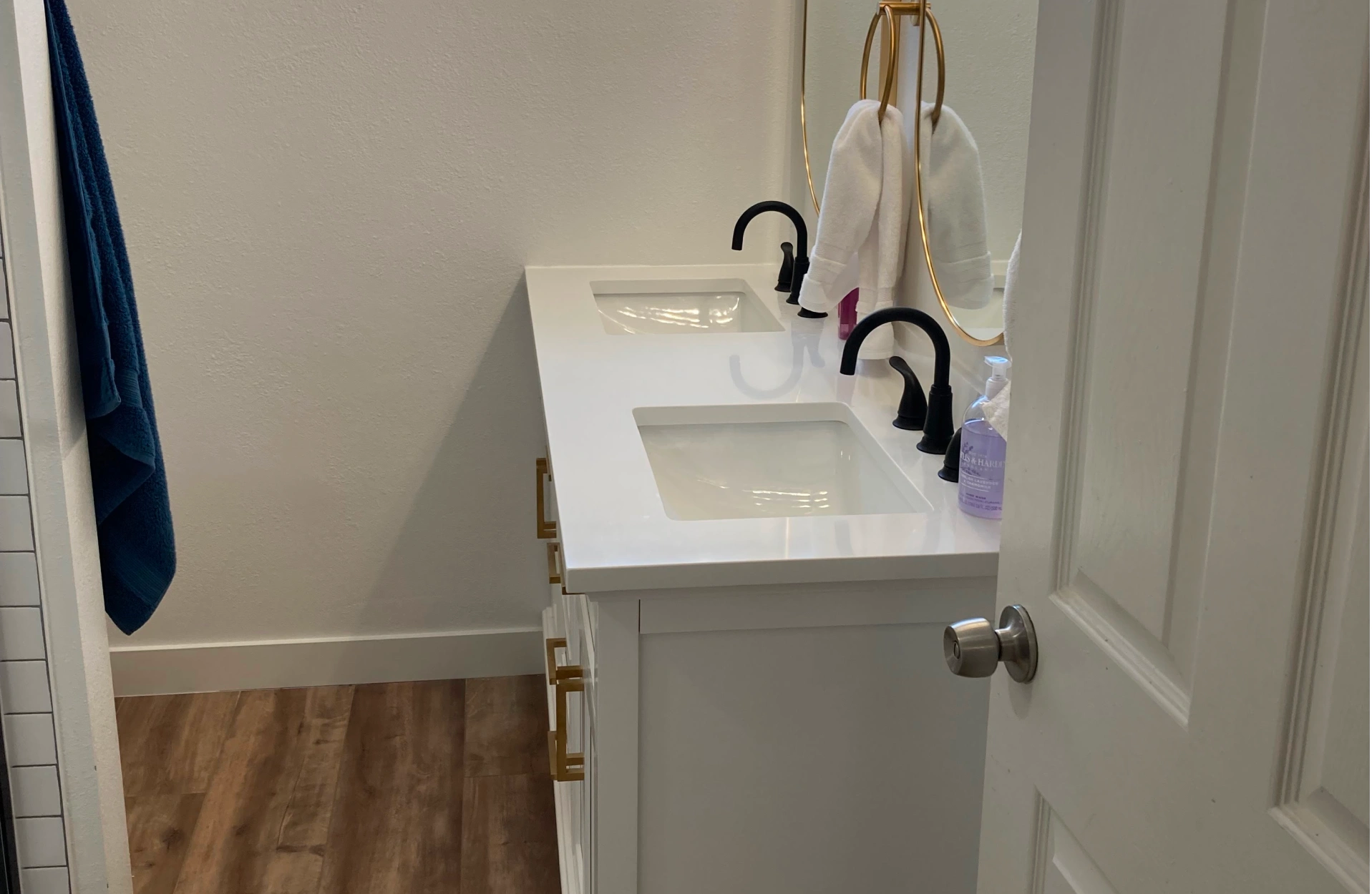A bathroom with a white double vanity